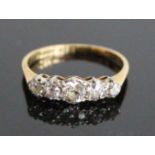 A yellow and white metal diamond half eternity ring, comprising five graduated Old European cut