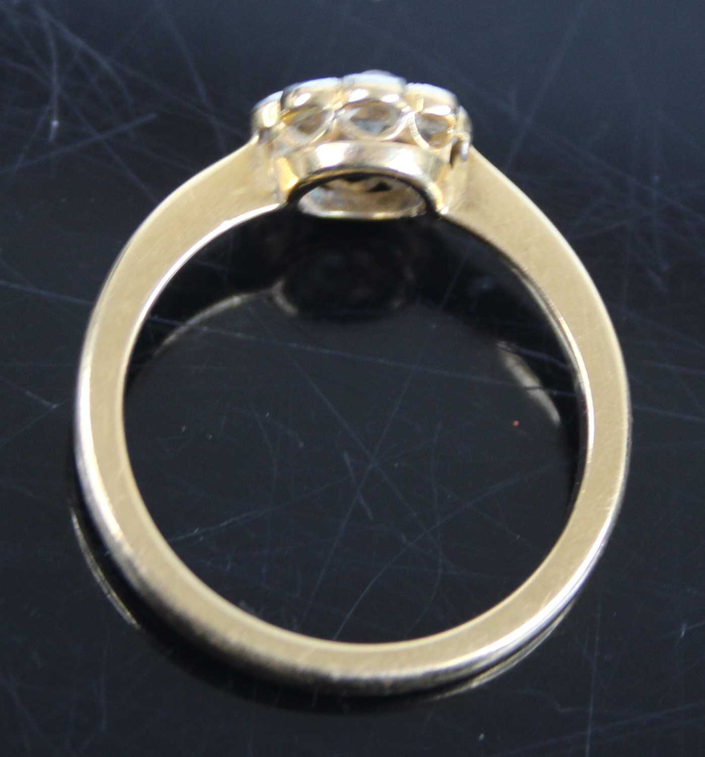 An 18ct gold diamond flower head cluster ring, arranged as a centre round cut within a surround of - Image 6 of 8