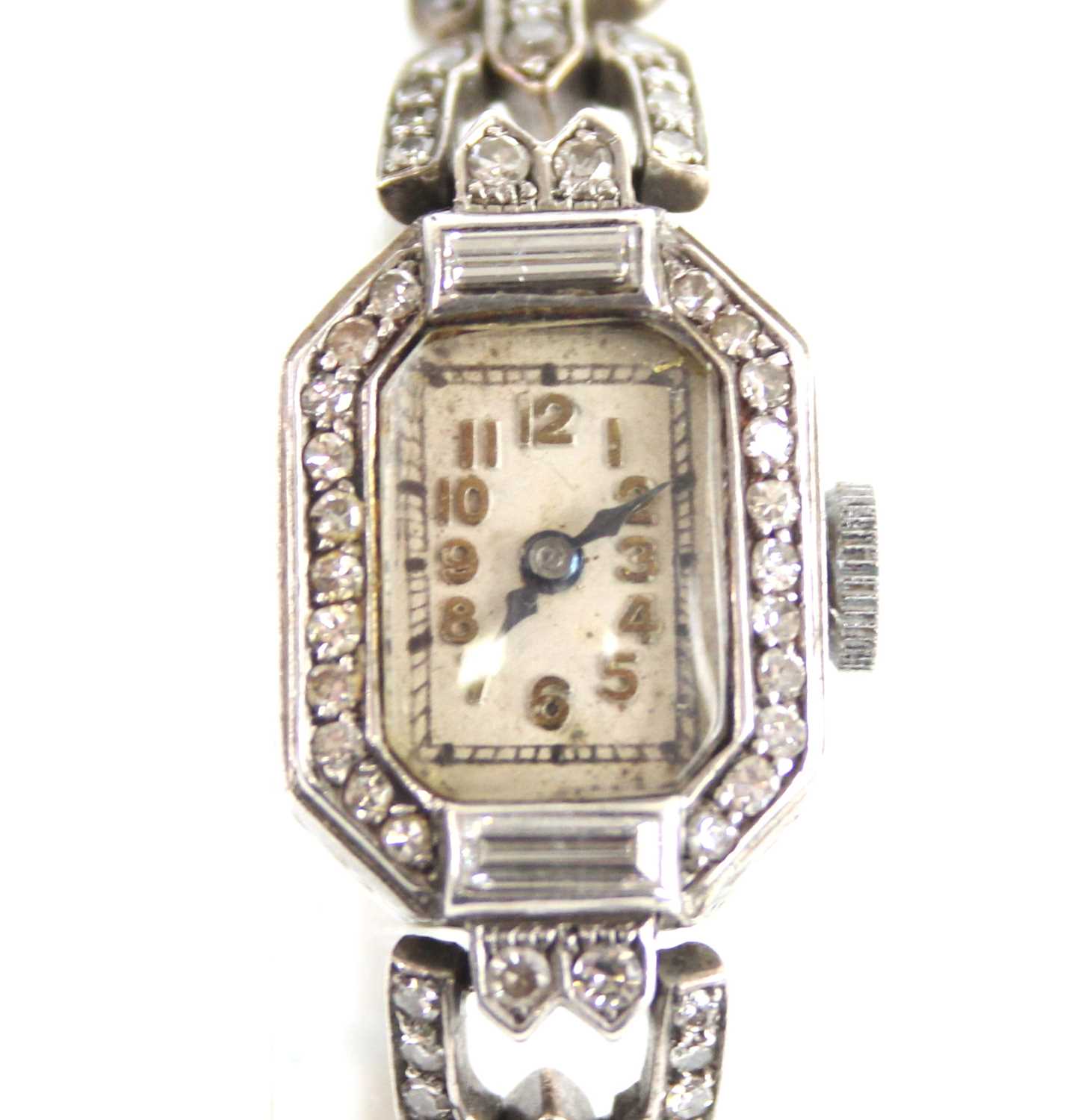 A white metal diamond set Art Deco lady's manual wind cocktail watch, having an octagonal cream