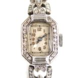 A white metal diamond set Art Deco lady's manual wind cocktail watch, having an octagonal cream
