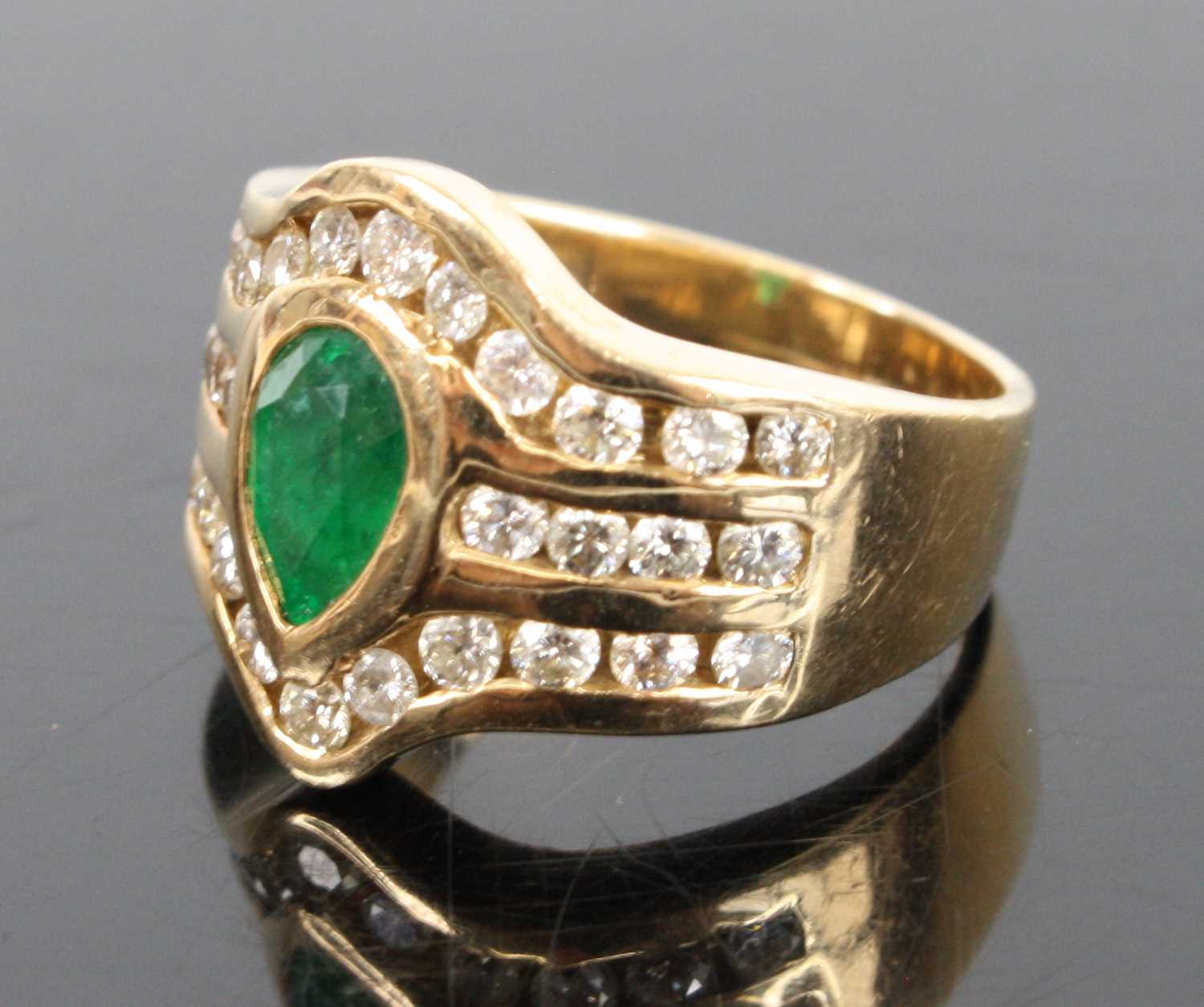 A 14ct yellow gold emerald and diamond dress ring, featuring a centre pear cut emerald in a bezel - Image 3 of 4