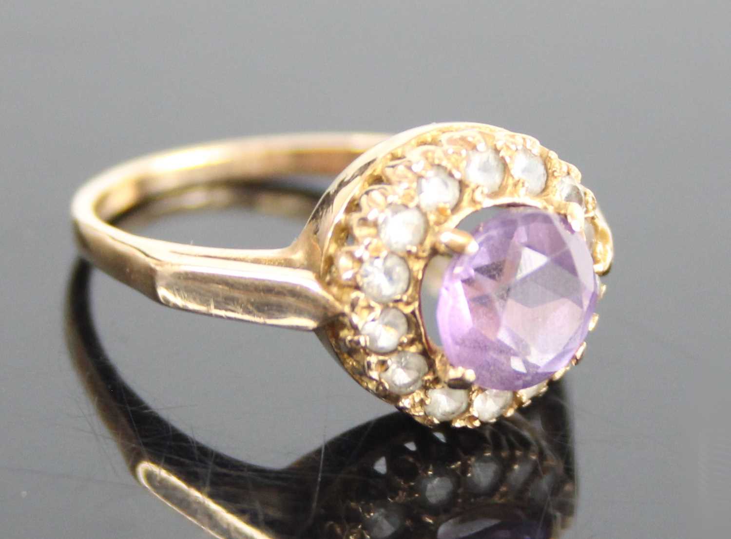 A 9ct yellow gold, amethyst and topaz circular cluster ring, having a centre round amethyst within a