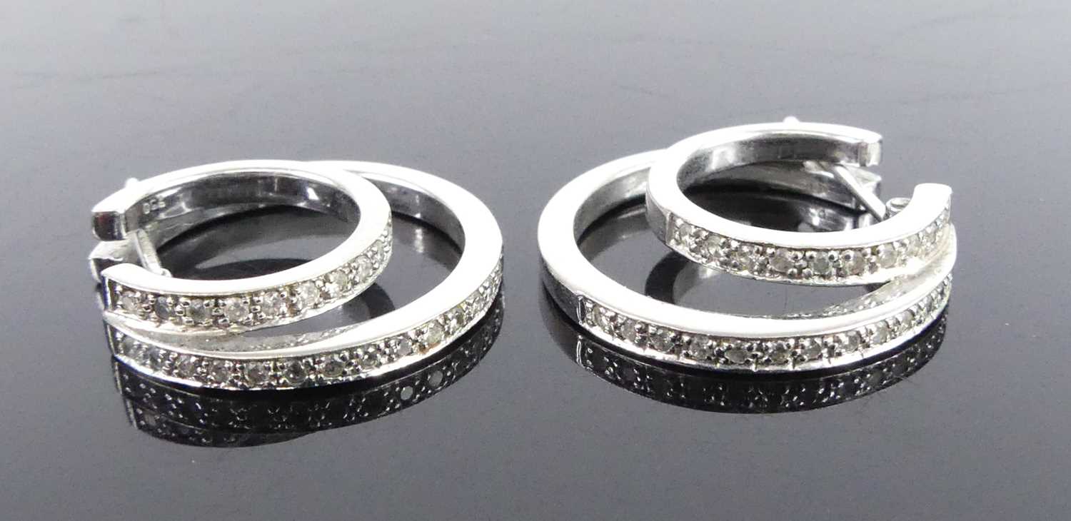 A pair of 18ct white gold diamond double hoop earrings, each featuring an inner hoop with ten and an