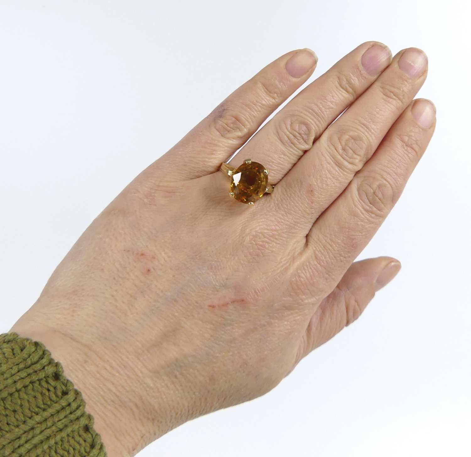 A yellow metal citrine single stone ring, featuring an oval citrine in a four-claw setting with - Image 7 of 7