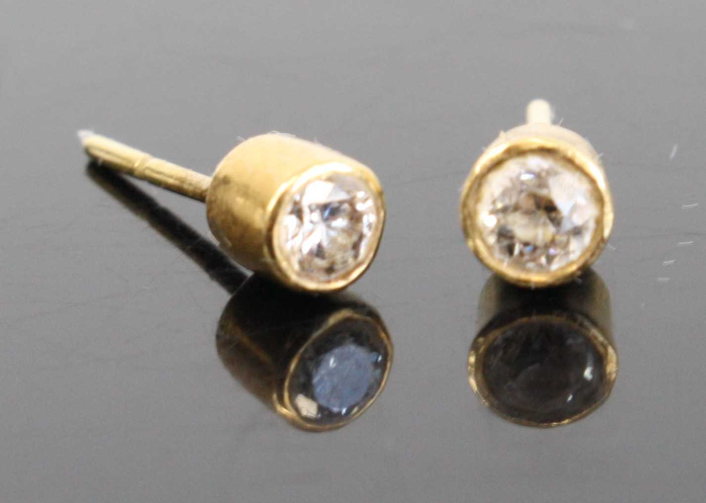 A pair of yellow metal diamond ear studs, the bezel set round cut diamonds each dia. approx 3.6mm - Image 2 of 3