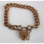 A 9ct gold curblink bracelet, with heart shaped padlock clasp and safety chain, 23.7g, 22cm