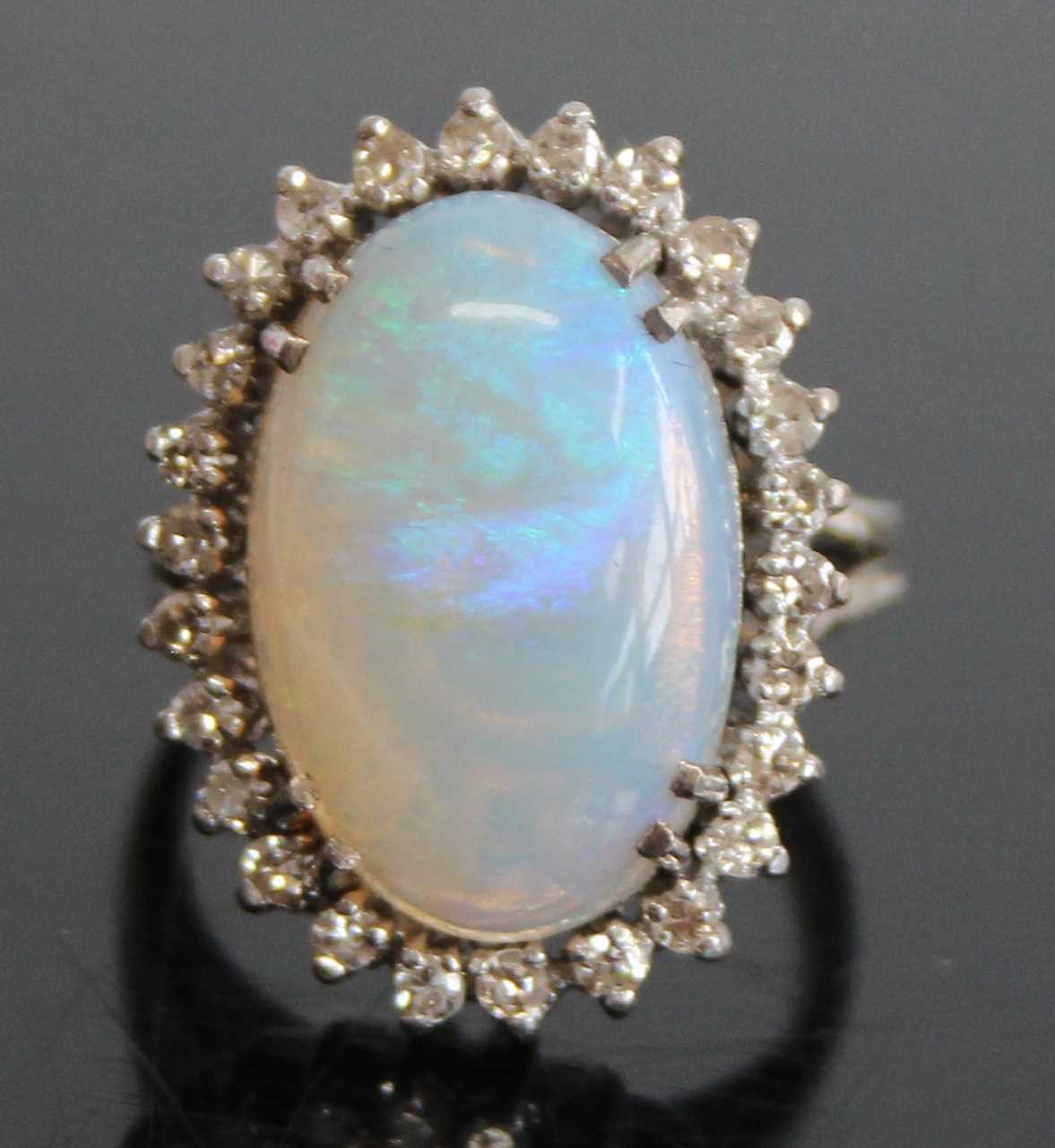 A 9ct white gold, opal and diamond oval cluster ring, comprising a central opal cabochon within a - Image 2 of 6