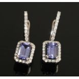 A pair of white metal, tanzanite and diamond drop earrings, each featuring a rectangular cut