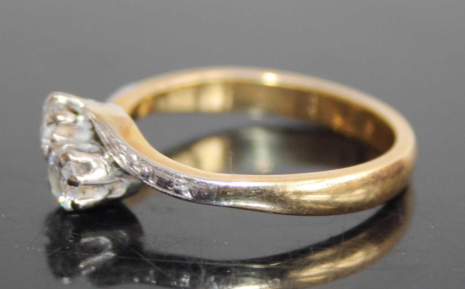 An 18ct gold diamond crossover ring, arranged as two claw set round cut diamonds, total diamond - Image 4 of 6