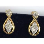 A pair of yellow and white metal diamond drop earring, each with five round brilliant cut diamonds