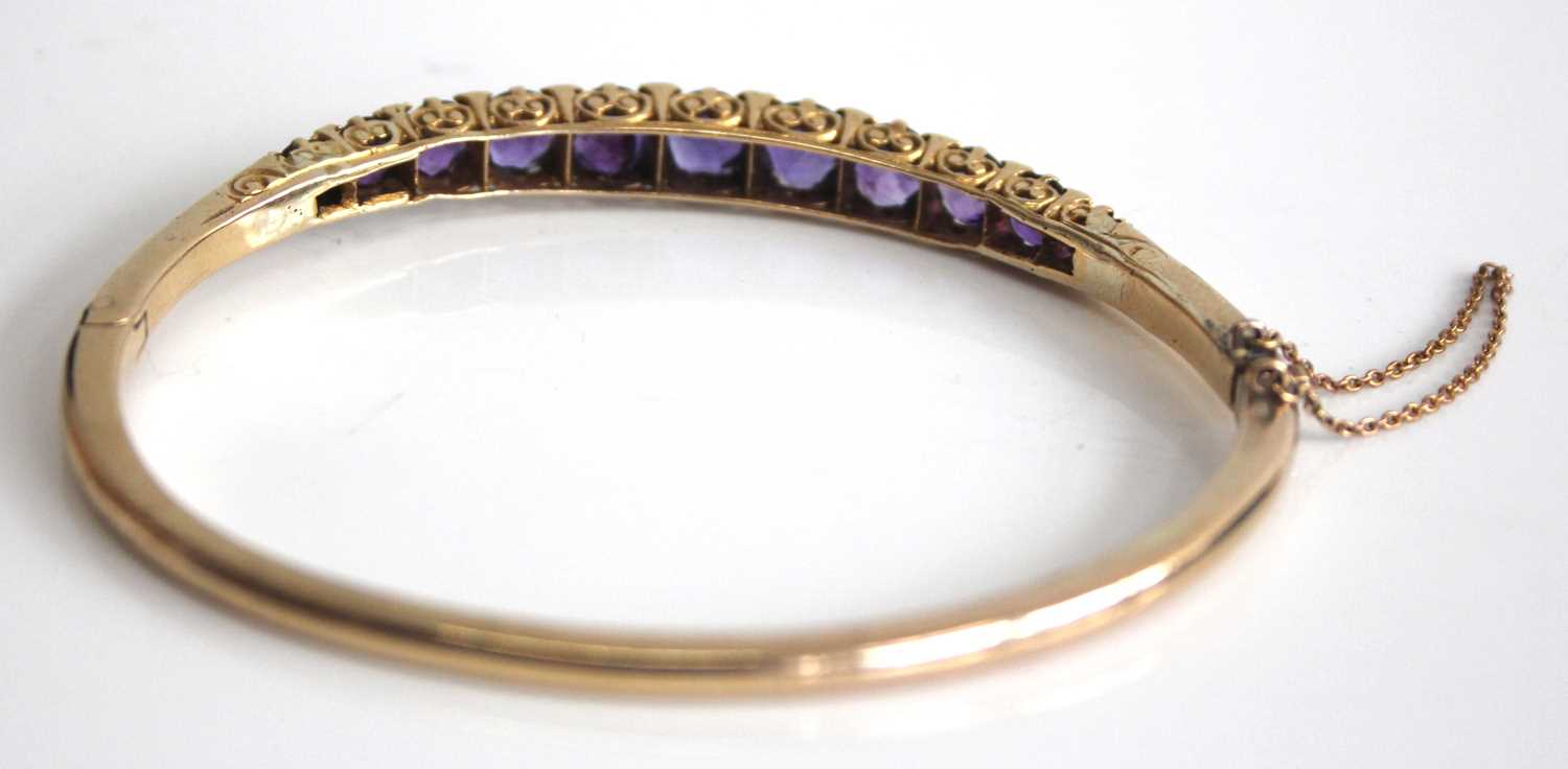 A yellow metal, amethyst and diamond point set hinged bangle, arranged as eleven graduated round cut - Image 2 of 4