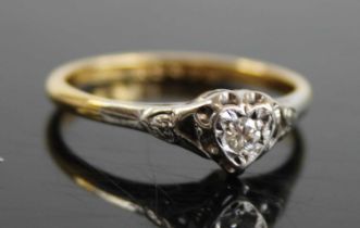 An 18ct gold diamond solitaire ring, the heart shaped illusion setting with a single round cut