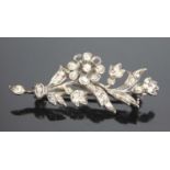 A white and yellow metal diamond floral spray brooch featuring 46 Old European cut diamonds in grain