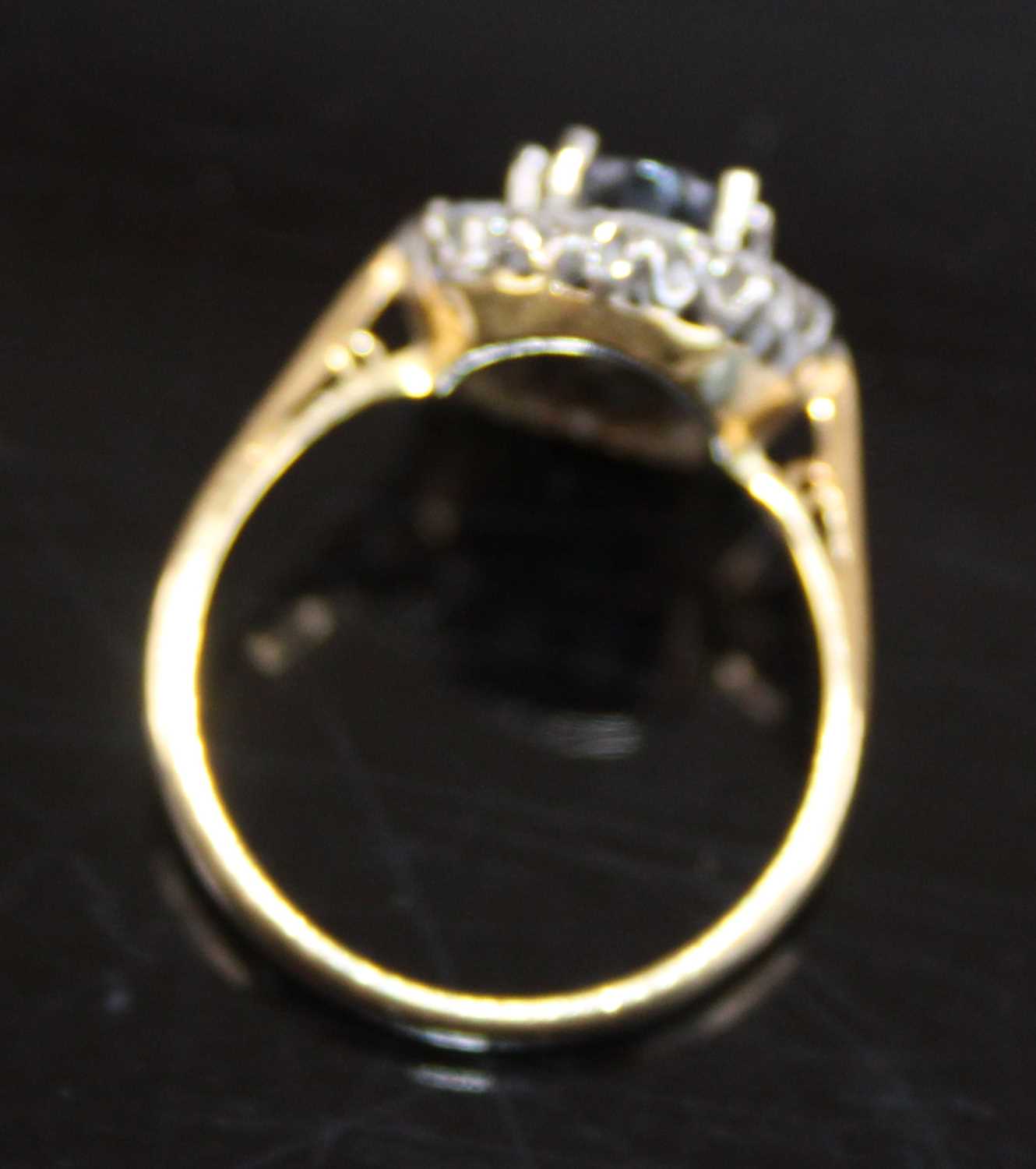 A yellow and white metal, sapphire and diamond oval cluster ring, the centre sapphire within a - Image 6 of 7