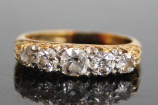 An 18ct gold diamond five-stone half hoop ring, arranged as claw set graduated old round cuts,