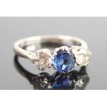 A white metal, sapphire and diamond three-stone ring, featuring a centre oval sapphire with an Old