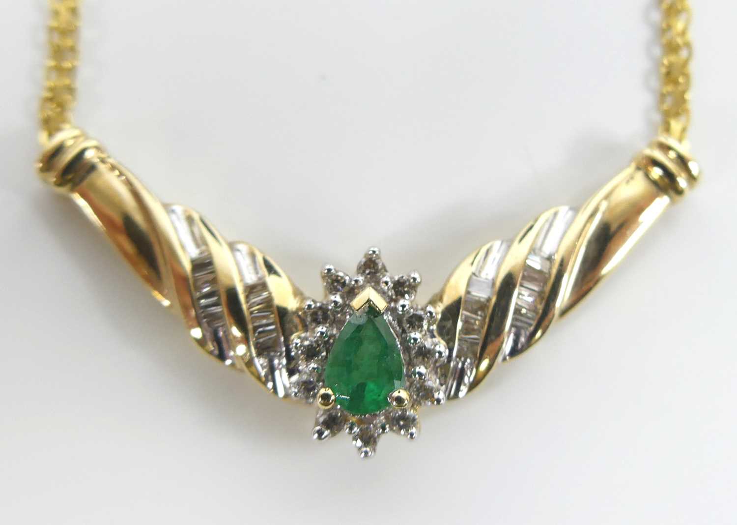 A yellow metal, emerald and diamond pear shaped cluster pendant, comprising a pear cut emerald - Image 2 of 5