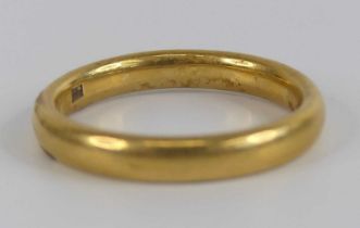 A yellow metal 3.2mm court shaped wedding band, size approx N, gross weight 5.6g, stamped and tested