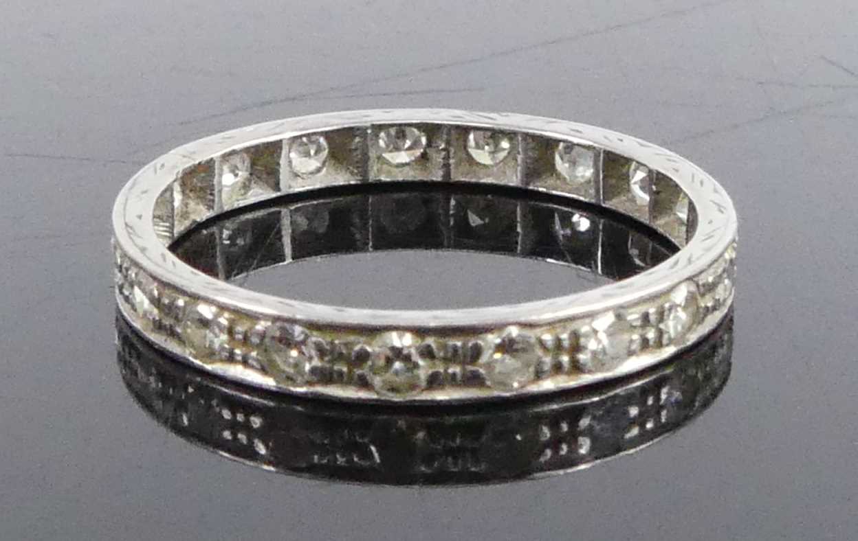 A white metal diamond full hoop eternity ring, comprising 19 single cut diamonds in grain and