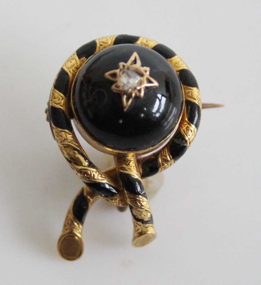 A late Victorian yellow metal mourning brooch, having a round 12.5mm garnet cabochon and a 2.35mm