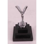 A miniature model of The Spirit of Ecstasy, mounted upon a stepped polished hardstone plinth, h.