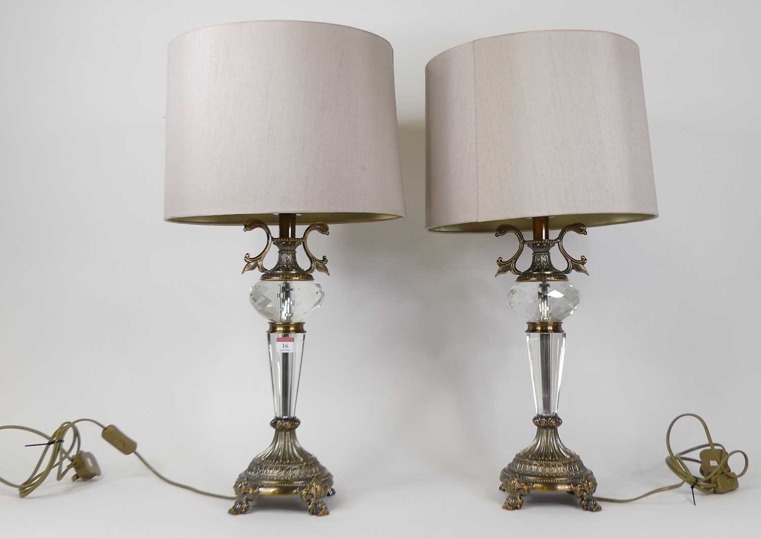 A pair of modern brass and cut glass table lamps, each having a beige shade, height including