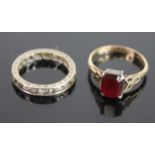 A 9ct gold and silver set garnet dress ring, size M; together with a white metal and cz set eternity