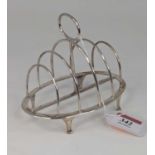 A George V silver toast rack having four arched divisions, with loop handle, maker Walker & Hall,