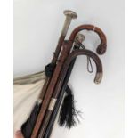 A Victorian ebonised wooden walking stick, having a silver top, length 91cm; together with a stained