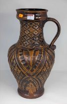 A West German brown glazed pottery jug, having incised decoration, height 46cm