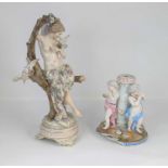 A continental porcelain figure of a lady shown sitting on a tree, height 33cm, together with a