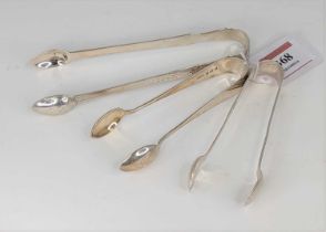 A pair of 19th century white metal sugar tongs with bright cut engraved decoration, together with