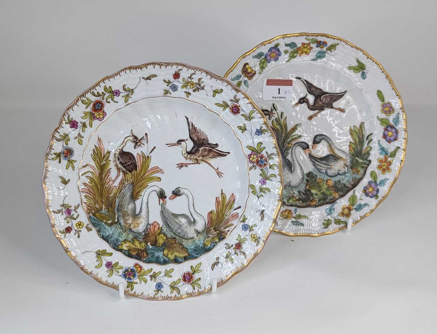 A pair of continental porcelain plates, relief decorated after the Meissen Swan service, possibly