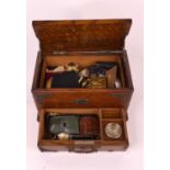 An early 20th century metal mounted oak jewellery box, containing a collection of costume