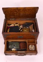 An early 20th century metal mounted oak jewellery box, containing a collection of costume