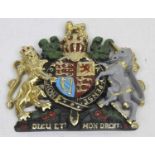 A painted composite plaque of the Royal Coat of Arms, 15 x 14cm