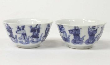 A pair of Chinese blue & white glazed porcelain teabowls, each underglaze decorated with figures,