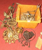 A collection of metalware, mainly toasting forks and brass fire tools