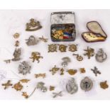 A collection of military cap badges, to include South Africa Defence Force and Belgian Anti-Aircraft
