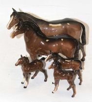 A Beswick model of a horse, chestnut gloss, height 20cm, together with four further Beswick models