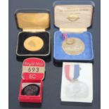 A commemorative gold plated medallion, together with a commemorative nickel silver medallion from