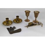 A collection of antique brass ware to include two travel communion cups, a Brighton bun pair of