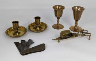 A collection of antique brass ware to include two travel communion cups, a Brighton bun pair of