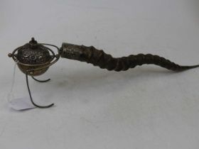 An Indian white metal oil lamp of spherical shape, on a gimbal support, having white metal capped
