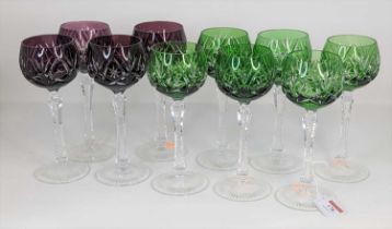 A set of six green and a set of four purple glass wineglasses, each with star cut decoration, height