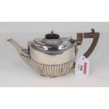 A George V silver bachelor's teapot, of half reeded oval form, maker William Hutton & Sons,