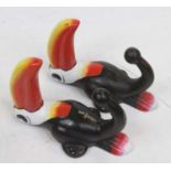 A pair of painted metal coat hooks, each in the form of a Guinness Toucan