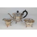 An Edwardian silver bachelor's three-piece tea service, each piece having a wavy rim to a banded