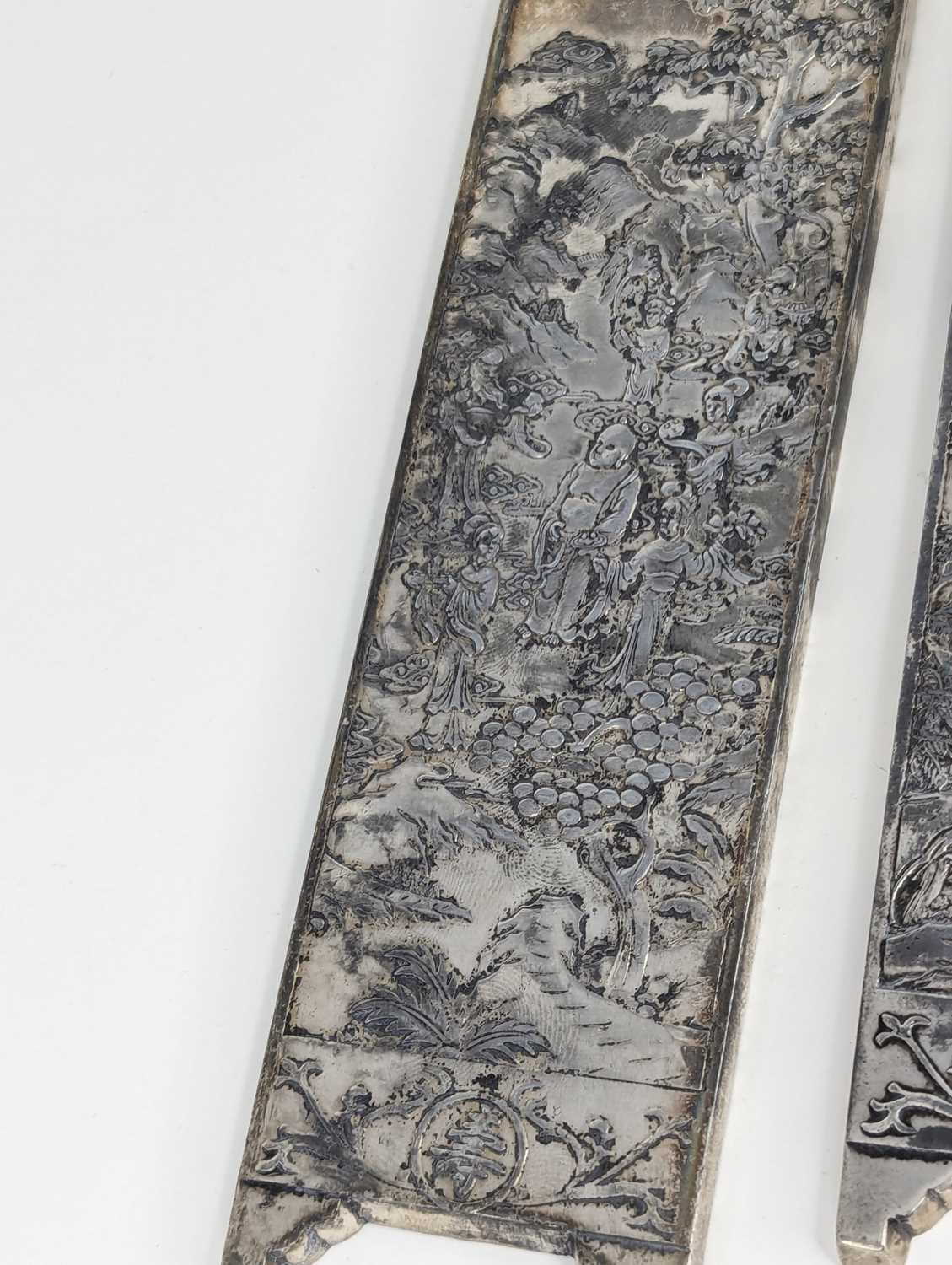 A pair of Chinese export white metal panels, each relief decorated with various figures within - Image 4 of 5