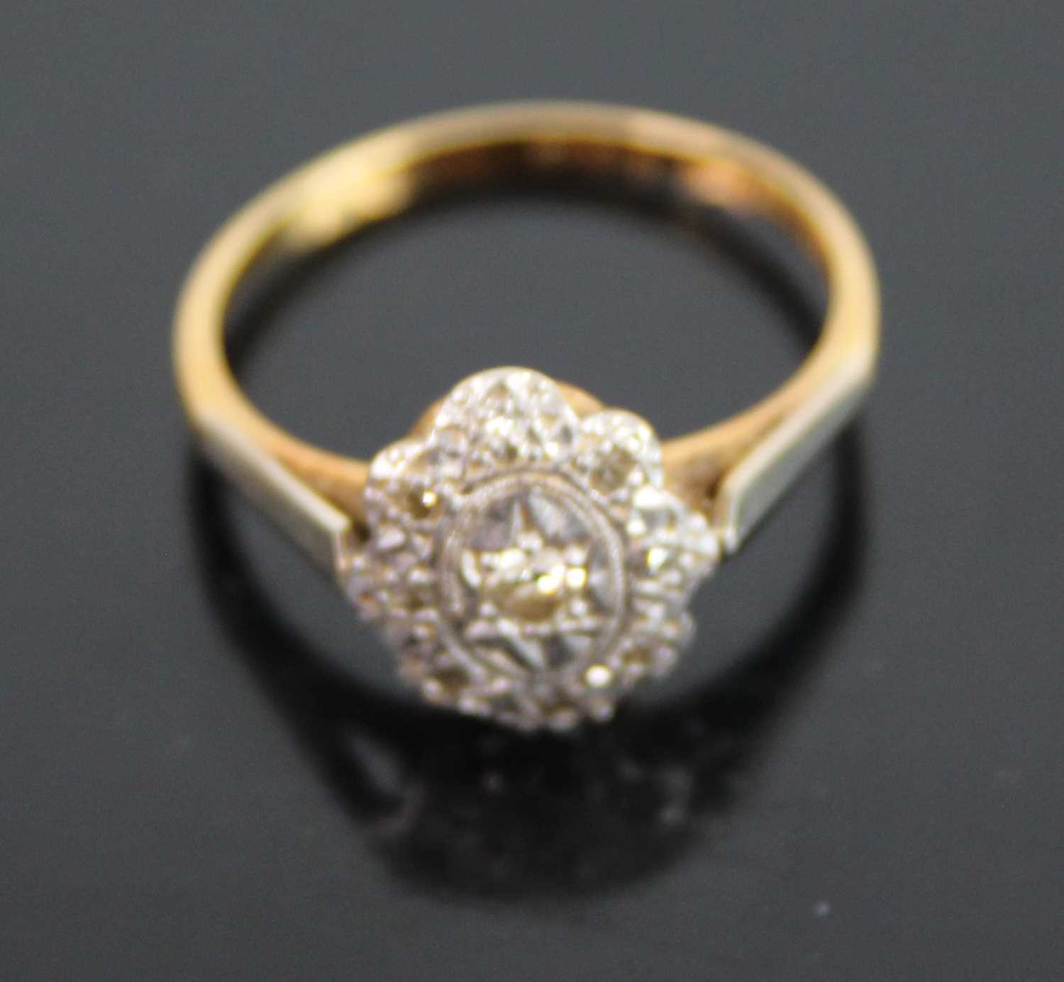 An Art Deco 18ct gold and platinum diamond tablet ring, the oval flower head setting centre set with - Image 2 of 2